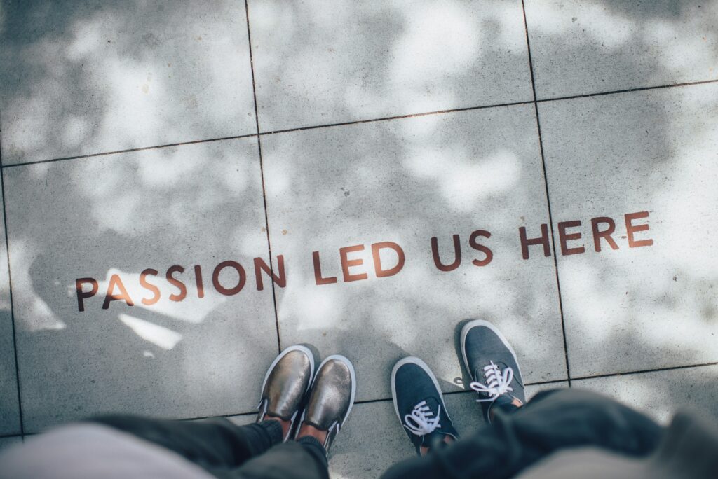 What is Digital PR? 2 An image showing a pavement with 'Passion led us here' written on it. Two pairs of legs can be seen standing next to the text